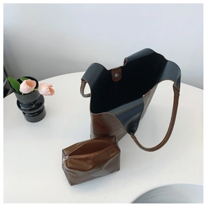 Top view of brown leather tote bag set with matching small zipper pouch inside