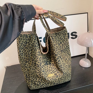 Large leopard print tote bag for women made of durable canvas material shown in lifestyle scene