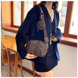 Detail of leopard print crossbody bag with detachable round coin purse and gold hardware