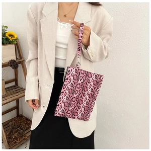 Detailed view of pink leopard print clutch bag with detachable wrist strap and silver clasp