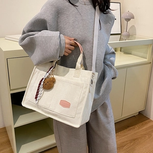 Large beige corduroy tote bag with pink handles and bear pendant crossbody display
