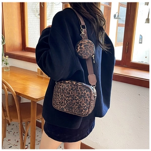 Leopard print crossbody bag with detachable round coin purse shown on female model