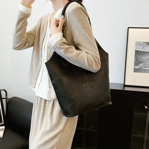 Vintage black textured leather tote bag with geometric stitching for women's daily commute