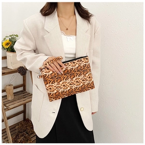 Detail of leopard print clutch bag with zipper closure and matching wristlet strap