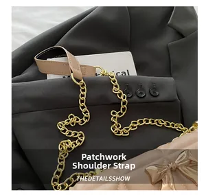 Detail of stitched shoulder strap with golden chain and bow buckle on quilted bag