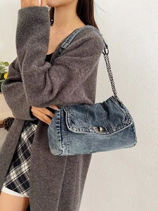 Vintage blue denim tote bag with metal chain strap and turn-lock closure for women