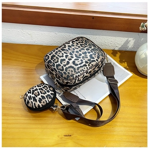 Detail of leopard print crossbody bag set with mini coin purse and wide shoulder strap