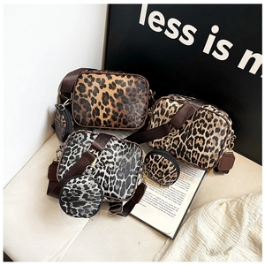 Detail view of leopard print crossbody bag set with adjustable strap and small round pouch
