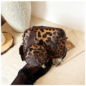 Detail of leopard print travel makeup bag set with gold hardware and wide strap