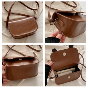 Detail view of brown PU leather crossbody bag with cute ear accents and interior space