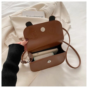 Detailed interior of the brown crossbody bag with bear ears showing storage capacity