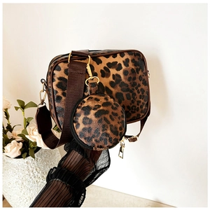 Detail view of leopard print crossbody bag set with small round coin purse and wide strap
