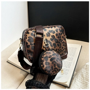 Detail of leopard print crossbody bag with mini round coin purse and adjustable strap