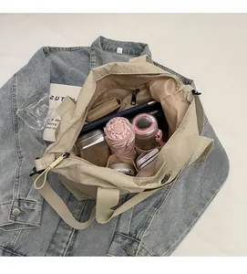 Close-up of the large nylon tote bag interior showing various pockets and storage space