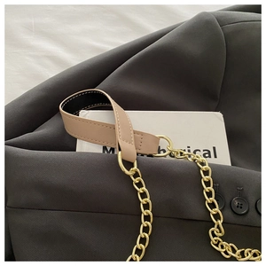 Detail of golden metal chain strap with khaki PU leather shoulder pad and D-ring buckle