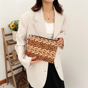 Fashionable leopard print clutch bag with wrist strap and zipper closure for daily styling