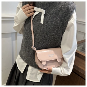 Detail showing pink mini crossbody bag with cute ear accents and silver lettering