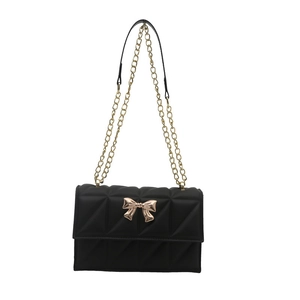 Fashionable black quilted crossbody bag with gold bow ornament and metal chain strap