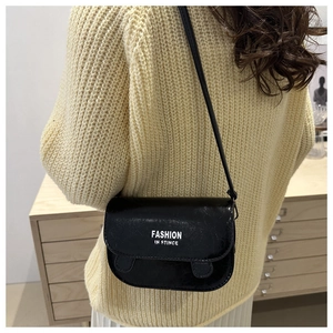 Detail of black glossy leather square crossbody bag with white fashion letter printing