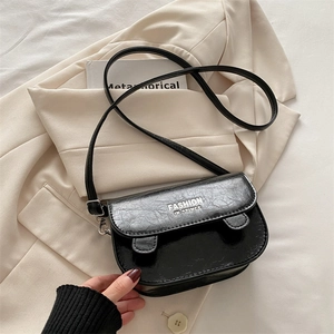 Minimalist black vintage textured crossbody square bag on stylish cream blazer