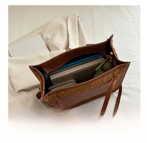 Top-down view of the brown PU leather tote bag showcasing its large interior storage capacity