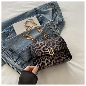 Detailansicht der Schultertasche mit Leopardenmuster und goldener Kette auf Weiß