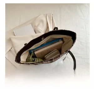 Internal view of a large plaid tweed tote bag showing space for books and tablets