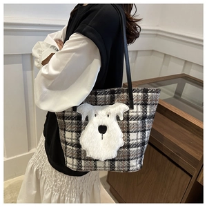 Detail of checkered tote bag featuring a 3D plush schnauzer dog patch and black straps