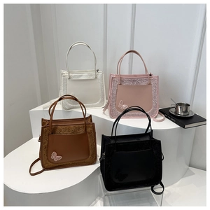 Detail of four faux fur and leather tote bags in cream, pink, brown and black with butterfly