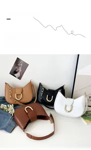 Detail of four crescent underarm bags in camel, black, white, and brown with gold D-buckles