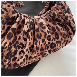 Detailed view of the leopard print pleats and corduroy texture on this shoulder bag