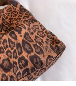 Detailed macro shot of the vintage leopard print fabric texture and high-quality stitching