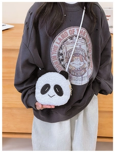 Mini plush panda crossbody bag shown on a child model in a warm home setting