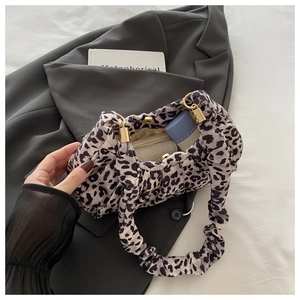 Detail showing spacious interior of leopard print faux fur handbag with magnetic closure