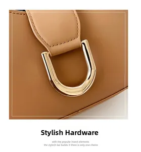 Detailed close-up of golden U-shaped metal hardware and brown litchi grain leather texture