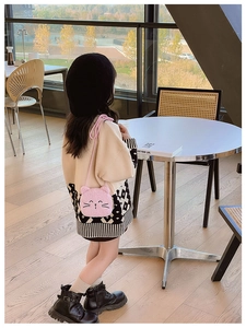 Close-up of a cute pink plush cat crossbody bag with detailed embroidery for kids