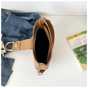 Detail shot of khaki shoulder bag interior featuring zipper pocket and gold hardware
