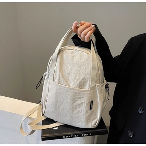 Mini sac à dos mode en nylon blanc cassé avec poignée et poches latérales à cordon