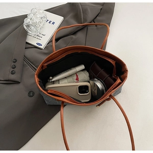 Top view of large grey tote bag interior showing capacity for cosmetics and phone