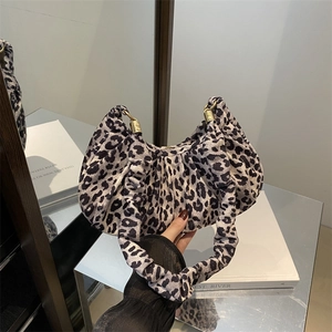 Detail of leopard print hobo bag with pleated texture and golden metal hardware