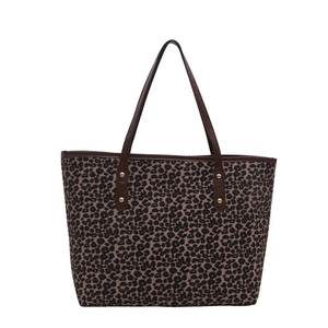 Fashionable leopard print tote bag with brown handles and gold rivets on white background