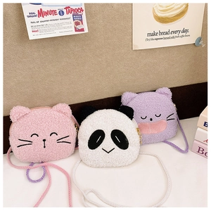Close-up of cute plush panda and cat coin purses with woven chain straps and zippers