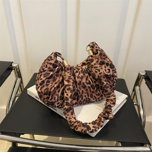 Detail of leopard print pleated shoulder bag featuring elegant golden metal rings