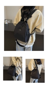 Detail of a black nylon versatile backpack with metal buckles and woven shoulder straps