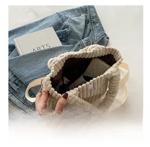 Macro shot of corduroy bucket bag interior showing spacious capacity for phone and items