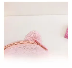 Detail view of pink plush panda bag showing soft lamb wool texture and zipper closure
