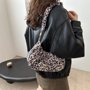 Detail of leopard print hobo bag with trendy scrunchie strap and stylish metal hardware