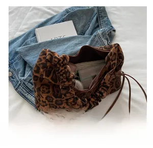 Detail view of leopard print tote bag interior showing large capacity and ruched handle