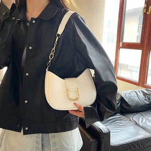 White minimalist half-moon underarm bag with gold D-buckle and chain strap on a model
