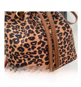 Detail of leopard print bucket bag with leather drawstring and gold metal eyelets